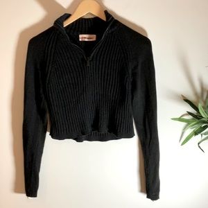 Urban Outfitters cropped black sweater with white stripes on sleeves. Size XS